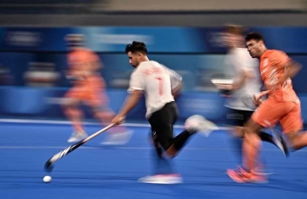 Canada's Gabriel Wing-Chuen Ho-Garcia carries the ball during the men's pool B match of the Tokyo 2020 Olympic Games field hockey competition against...