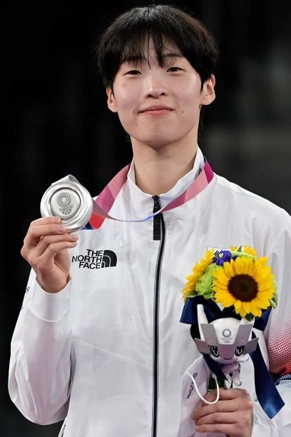 Silver medalist South Korea's Lee Da-bin poses on the podium after the taekwondo women's +67kg bronze medal A bout during the Tokyo 2020 Olympic...