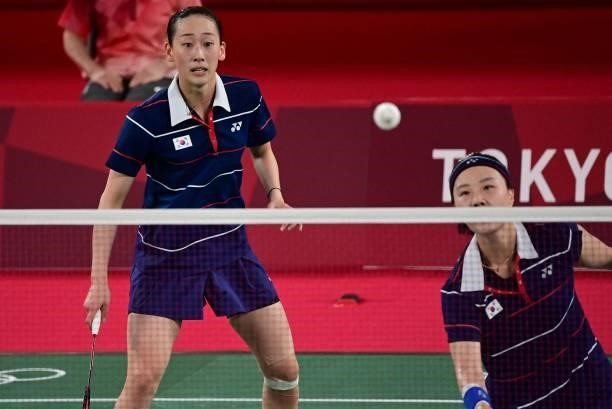 South Korea's Lee So-hee watches South Korea's Shin Seung-chan hit a shot in their women's doubles badminton group stage match against China's Li...