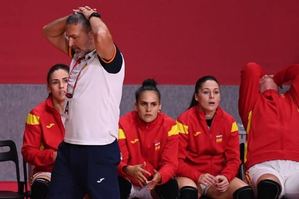 Spain's coach Carlos Enrique Viver Arza walks past his players during the women's preliminary round group B handball match between France and Spain...