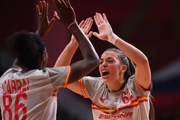 Spain's right back Paula Arcos Poveda celebrates after scoring with a teammate during the women's preliminary round group B handball match between...