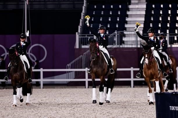 Dorothee Schneider of Germany, Isabell Werth of Germany and Jessica von Bredow-Werndl of Germany ride together after the medal ceremony of dressage...