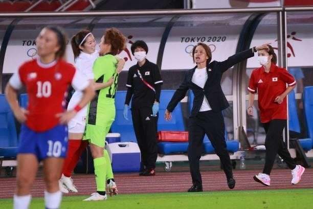 Japan's coach Asako Takakura reacts after their team's goal during the Tokyo 2020 Olympic Games women's group E first round football match between...