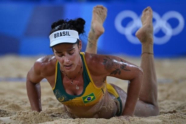 Brazil's Agatha Bednarczuk gets back to her feet in their women's preliminary beach volleyball pool C match between Brazil and China during the Tokyo...