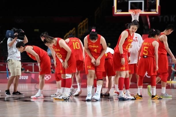 China's players bow down after their victory in the women's preliminary round group C basketball match between China and Puerto Rico during the Tokyo...
