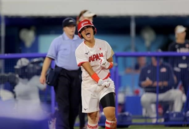 Japan's Yu Yamamoto celebrates after her scoring during the fifth inning of the Tokyo 2020 Olympic Games softball gold medal game between Japan and...