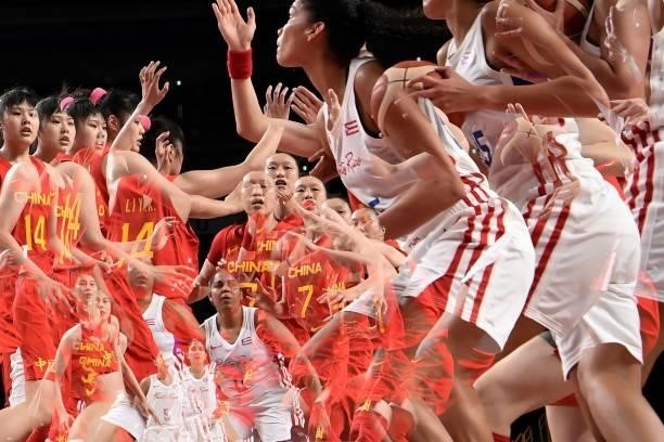 This miltiple exposure picture shows Chinese and Puerto Rico's players competing in the women's preliminary round group C basketball match between...