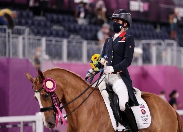 Bronze medallist Charlotte Dujardin of Britain ride on the course after the medal ceremony on day four of the Tokyo 2020 Olympic Games at Equestrian...