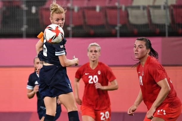 Britain's midfielder Sophie Ingle heads the ball during the Tokyo 2020 Olympic Games women's group E first round football match between Canada and...