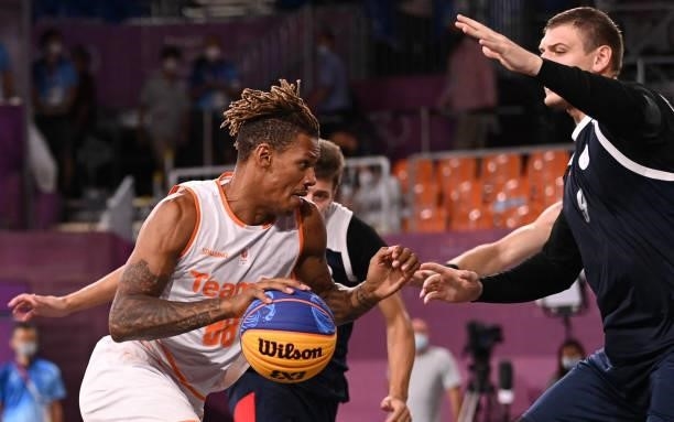 Netherlands' Jessey Voorn dribbles the ball past Russia's Ilia Karpenkov during the men's quarter final 3x3 basketball match between Netherlands and...
