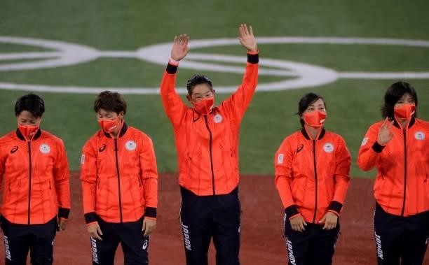 Japan's Yukiko Ueno waves on the podium after getting the gold medal during the medal ceremony for the softball competition in the Tokyo 2020 Olympic...