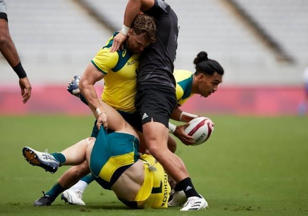 Henry Hutchison of Australia battle for the ball during the Rugby Pool A match between New Zealand and Australia on day four of the Tokyo 2020...