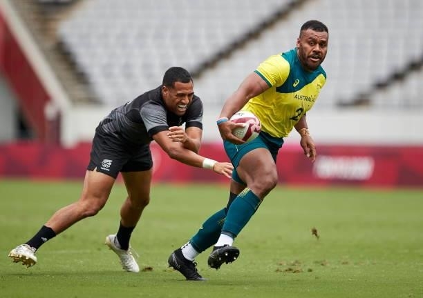 Samu Kerevi of Australia battle for the ball during the Rugby Pool A match between New Zealand and Australia on day four of the Tokyo 2020 Olympic...