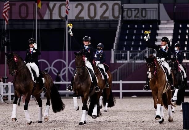 Dorothee Schneider of Germany, Isabell Werth of Germany and Jessica von Bredow-Werndl of Germany ride together with other medallists after the medal...