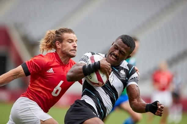 Jiuta Wainiqolo of Fiji and Tom Mitchell of Great Britain battle for the ball during the Rugby Pool B match between Fiji and Great Britain on day...