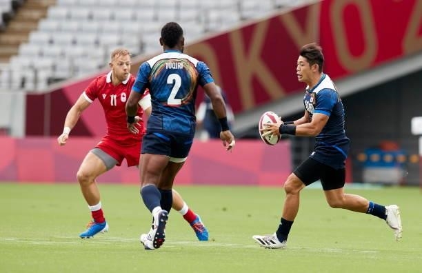 Harry Jones of Canada, Lote Tuqiri of Japan and Yoshikazu Fujita of Japan battle for the ball during the Rugby Pool B match between Canada and Japan...