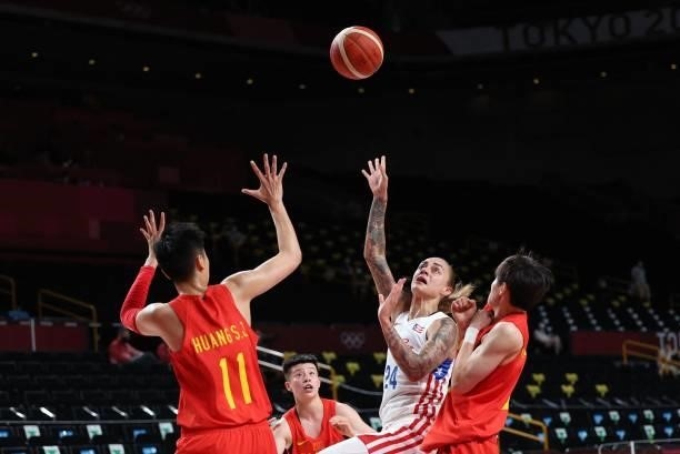 Puerto Rico's Jazmon Gwathmey goes to the basket past China's Huang Sijing in the women's preliminary round group C basketball match between China...