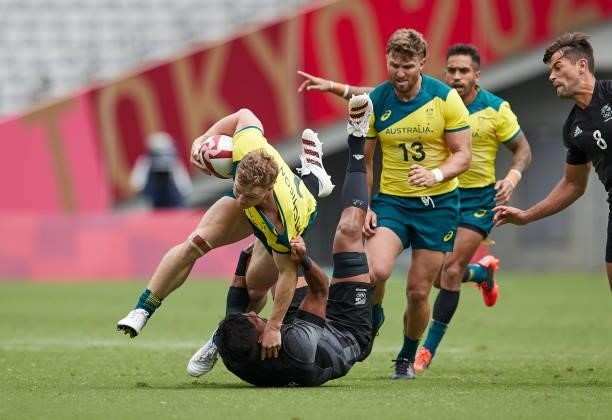 Henry Hutchison of Australia and Dylan Collier of New Zealand battle for the ball during the Rugby Pool A match between New Zealand and Australia on...