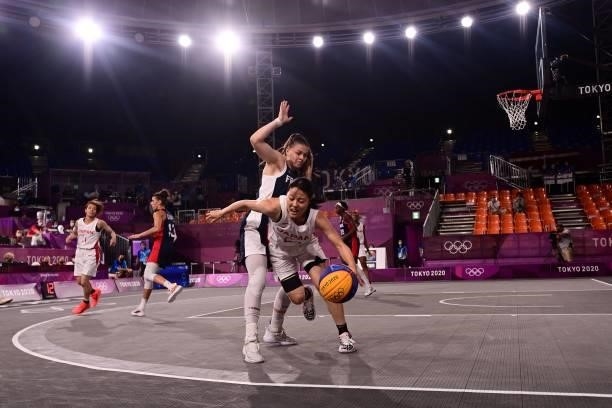 Japan's Mai Yamamoto dribbles the ball past France's Marie-Eve Paget during the women's quarter final 3x3 basketball match between Japan and France...