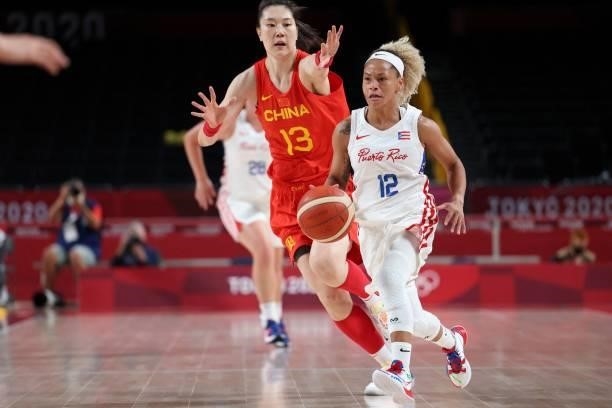 Puerto Rico's Dayshalee Salaman dribbles the ball past China's Sun Mengran in the women's preliminary round group C basketball match between China...
