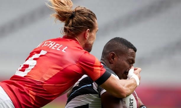 Jiuta Wainiqolo of Fiji and Tom Mitchell of Great Britain battle for the ball during the Rugby Pool B match between Fiji and Great Britain on day...