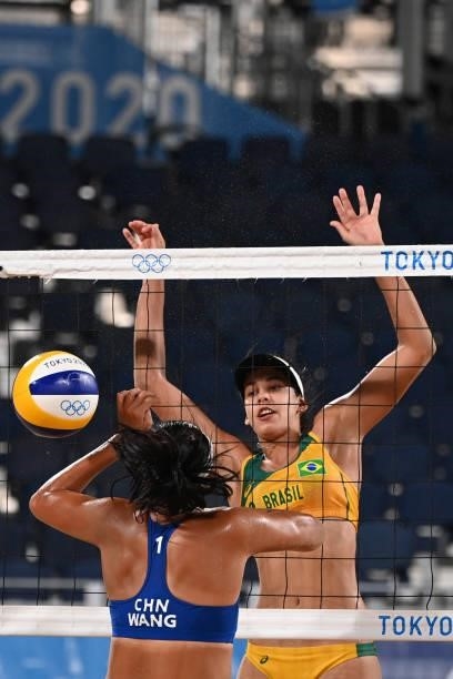 Brazil's Eduarda Santos Lisboa blocks a shot by China's Wang Fan during their women's preliminary beach volleyball pool C match between Brazil and...