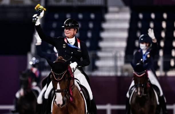 Gold medallist Isabell Werth of Germany rides on her horse after the medal ceremony.of dressage grand prix special team competition during the Tokyo...
