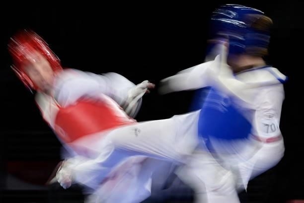 Poland's Aleksandra Kowalczuk and Britain's Bianca Walkden compete in the taekwondo women's +67kg bronze medal B bout during the Tokyo 2020 Olympic...