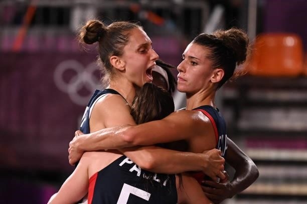 France's teammates celebrate at the end of the women's quarter final 3x3 basketball match between Japan and France at the Aomi Urban Sports Park in...
