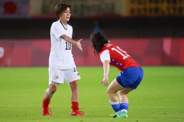 Japan's forward Mana Iwabuchi greets Chile's forward Javiera Grez after Japan won the Tokyo 2020 Olympic Games women's group E first round football...