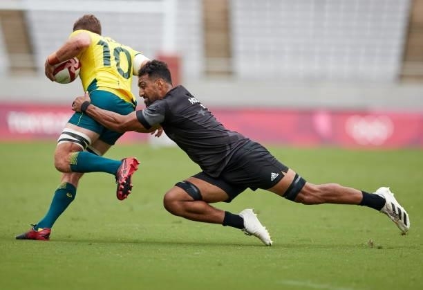 Henry Hutchison of Australia and Dillan Colier of New Zealand battle for the ball during the Rugby Pool A match between New Zealand and Australia on...
