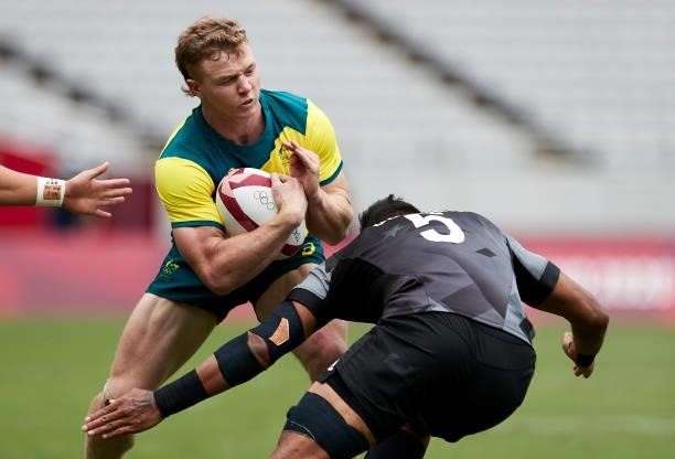 Henry Hutchison of Australia and Dillan Collier of New Zealand battle for the ball during the Rugby Pool A match between New Zealand and Australia on...