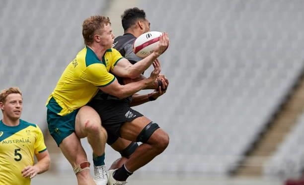 Henry Hutchison of Australia and Dillan Colier of New Zealand battle for the ball during the Rugby Pool A match between New Zealand and Australia on...