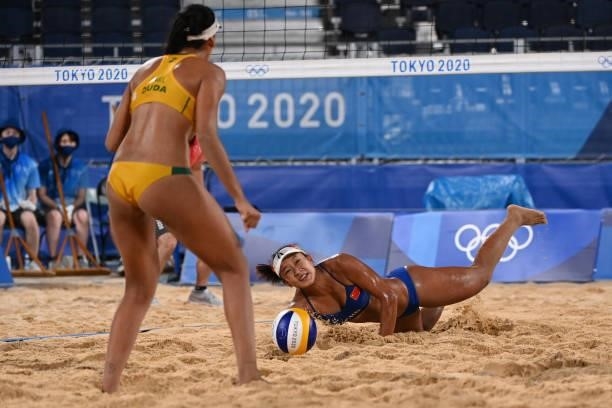 China's Xia Xinyi reaches for the ball in their women's preliminary beach volleyball pool C match between Brazil and China during the Tokyo 2020...