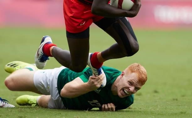 Johnstone Olindi of Kenya and Gavin Mullin of Ireland battle for the ball during the Rugby Pool c match between Kenya and Ireland on day four of the...