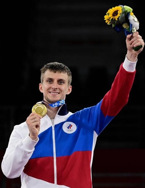 Gold medalist Russia's Vladislav Larin poses on the podium after the the taekwondo men's +80kg medal bouts during the Tokyo 2020 Olympic Games at the...