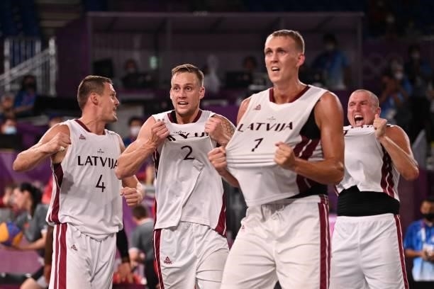 Latvia's teammates celebrate after wining at the end of the men's quarter final 3x3 basketball match between Latvia and Japan at the Aomi Urban...
