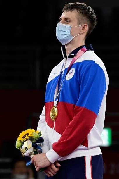 Gold medalist Russia's Vladislav Larin poses on the podium after the the taekwondo men's +80kg medal bouts during the Tokyo 2020 Olympic Games at the...