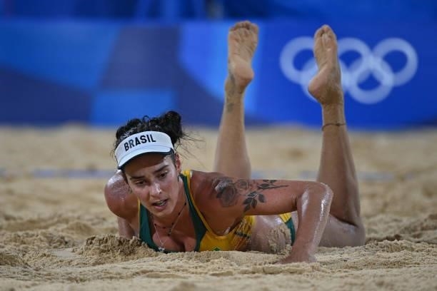 Brazil's Agatha Bednarczuk gets up in their women's preliminary beach volleyball pool C match between Brazil and China during the Tokyo 2020 Olympic...
