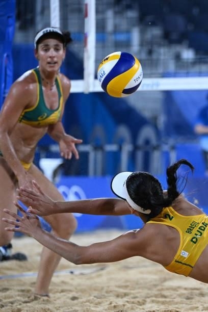 Brazil's Eduarda Santos Lisboa dives after a shot in their women's preliminary beach volleyball pool C match between Brazil and China during the...