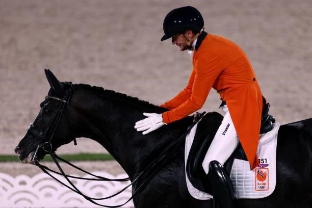 The Netherland's Edward Gal riding Total Us caresses his horse after competing in the dressage grand prix special team competition during the Tokyo...