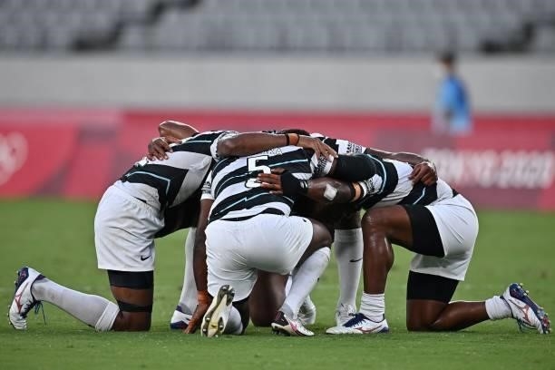 Fiji's players react after winning the men's final rugby sevens match between New Zealand and Fiji during the Tokyo 2020 Olympic Games at the Tokyo...