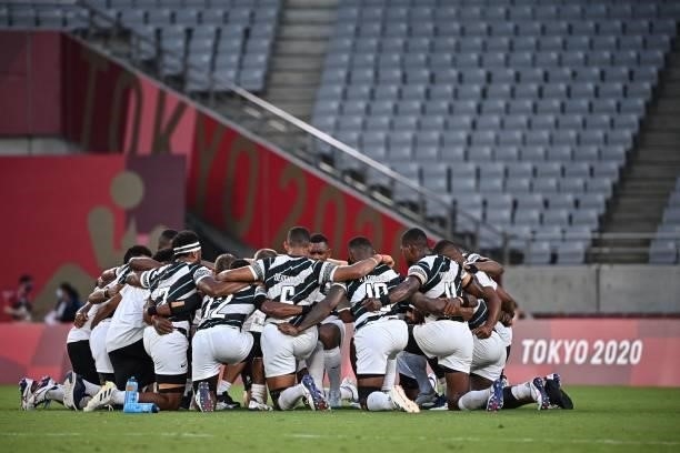 Fiji's players react after winning the men's final rugby sevens match between New Zealand and Fiji during the Tokyo 2020 Olympic Games at the Tokyo...
