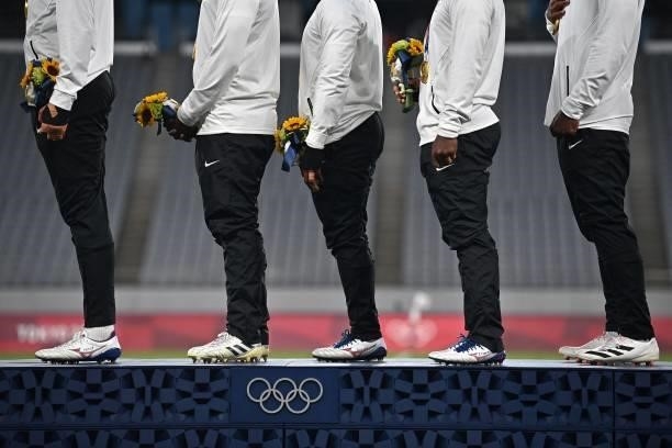 Fiji's players stand on the podium with their gold medals for the victory ceremony following the men's final rugby sevens match during the Tokyo 2020...