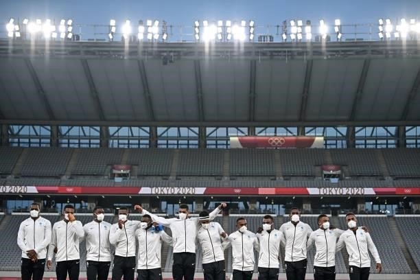 Fiji's players stand on the podium while waiting for the victory ceremony after the men's final rugby sevens match during the Tokyo 2020 Olympic...