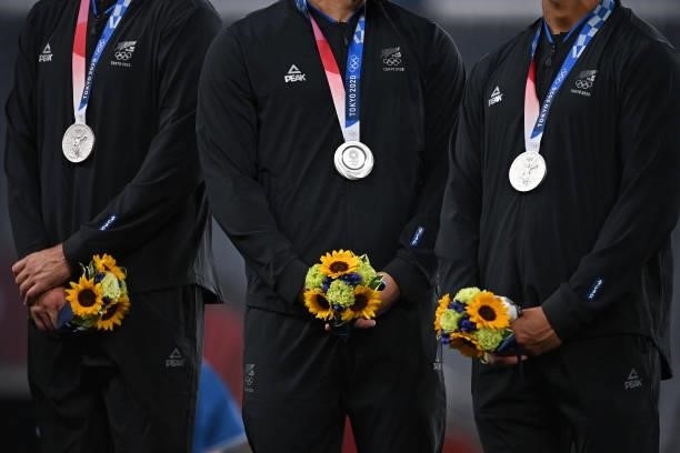Silver medallists from New Zealand stand on the podium for the victory ceremony after the men's final rugby sevens match during the Tokyo 2020...