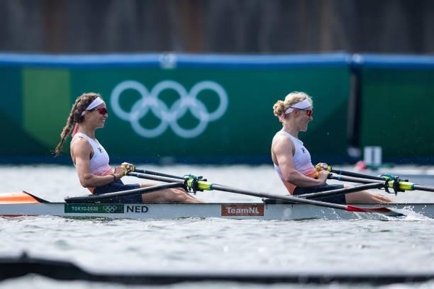 Roos de Jong of Netherland and Lisa Scheenaard of Netherland lie in the water during the men's semi-final in the lightweight double sculls during...