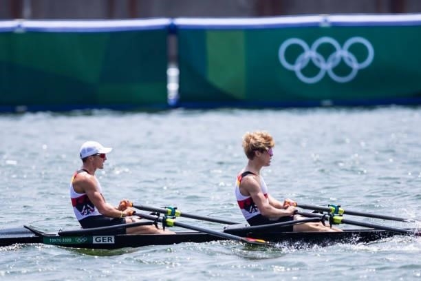 Jonathan Rommelmann of Germany and Jason Osborne of Germany lie in the water during the men's semi-final in the lightweight double sculls during...