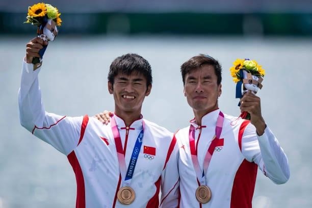 Zhiyu Liu of China and Liang Zhang of China lie in the water during the men's semi-final in the lightweight double sculls during Rowing on day five...