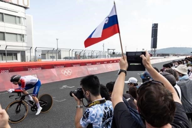 Fans watch as France's Remi Cavagna passes along the circuit during the men's cycling road individual time trial during the Tokyo 2020 Olympic Games...